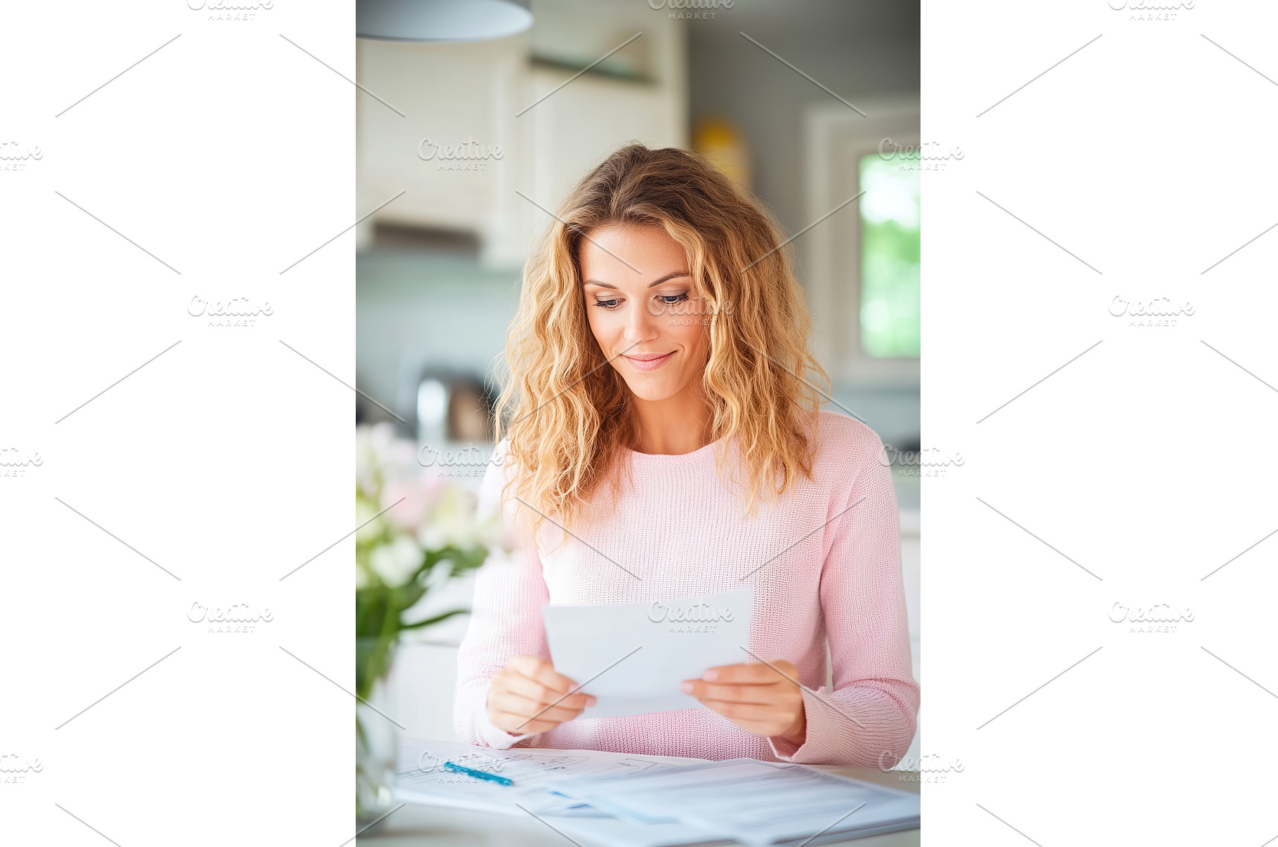 Woman Reads Letter at Table in, a Business Photo by Lermont51