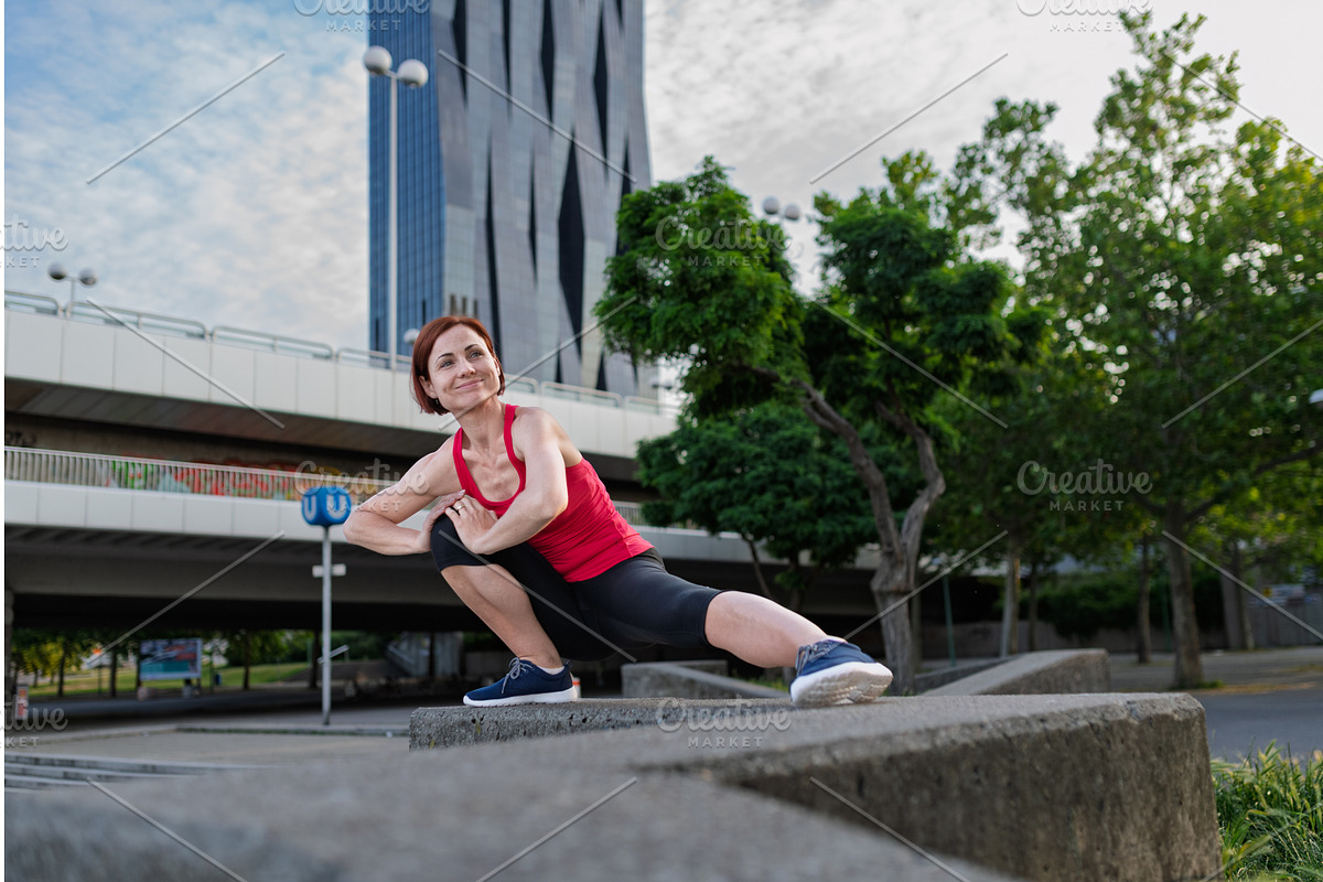 Woman working out in the city, doing, a Graphic by HalfPoint