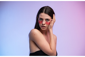 Woman applying pink eye patches for, a Health & Medical Photo by volodymyrshtun13795