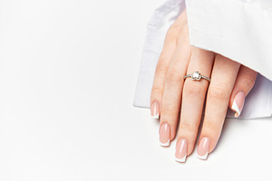 Woman hand showing french manicure and elegant ring on white bac, a Beauty & Fashion Photo by Olena Rudo