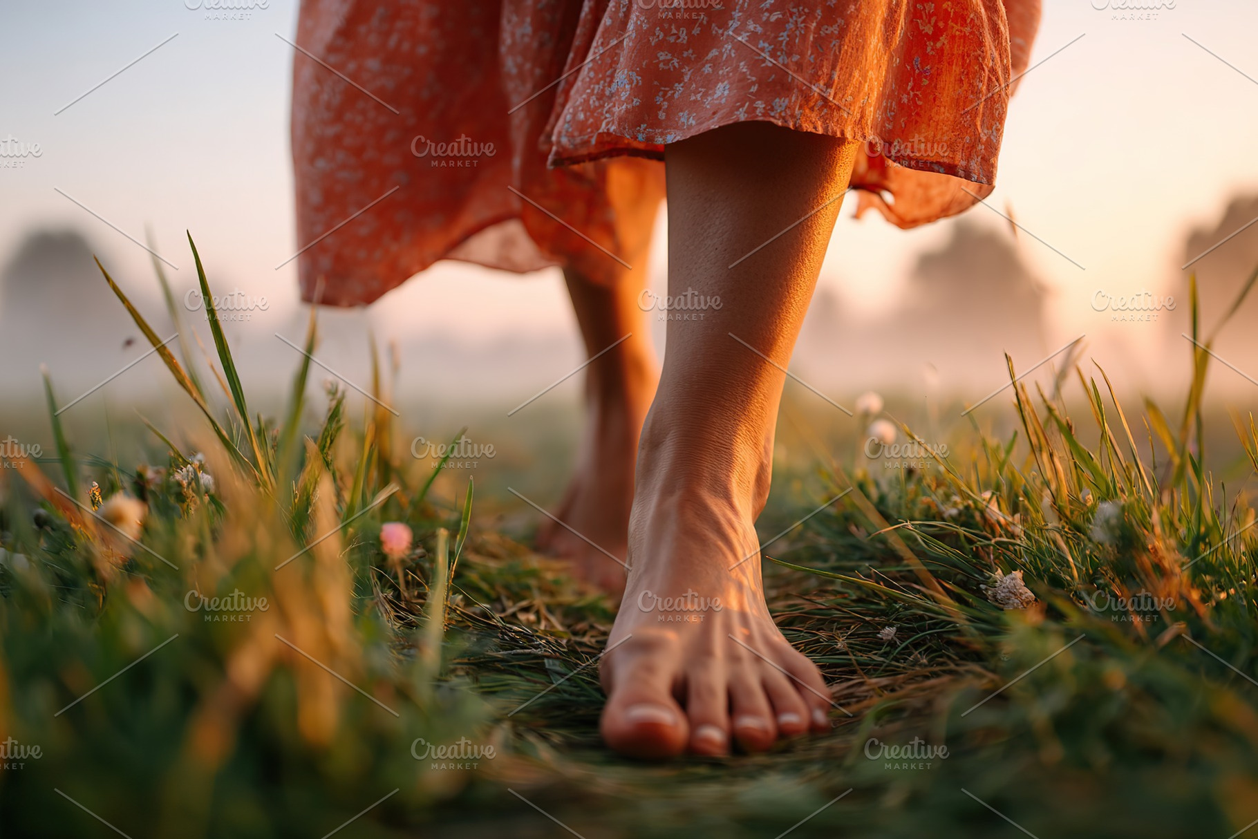 Walking barefoot through a green meadow at sunrise with dewy grass, a Person Photo by AlyaAnd