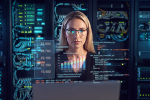 Professional female IT engineer (blonde woman in glasses) workin, a Technology Photo by Volff