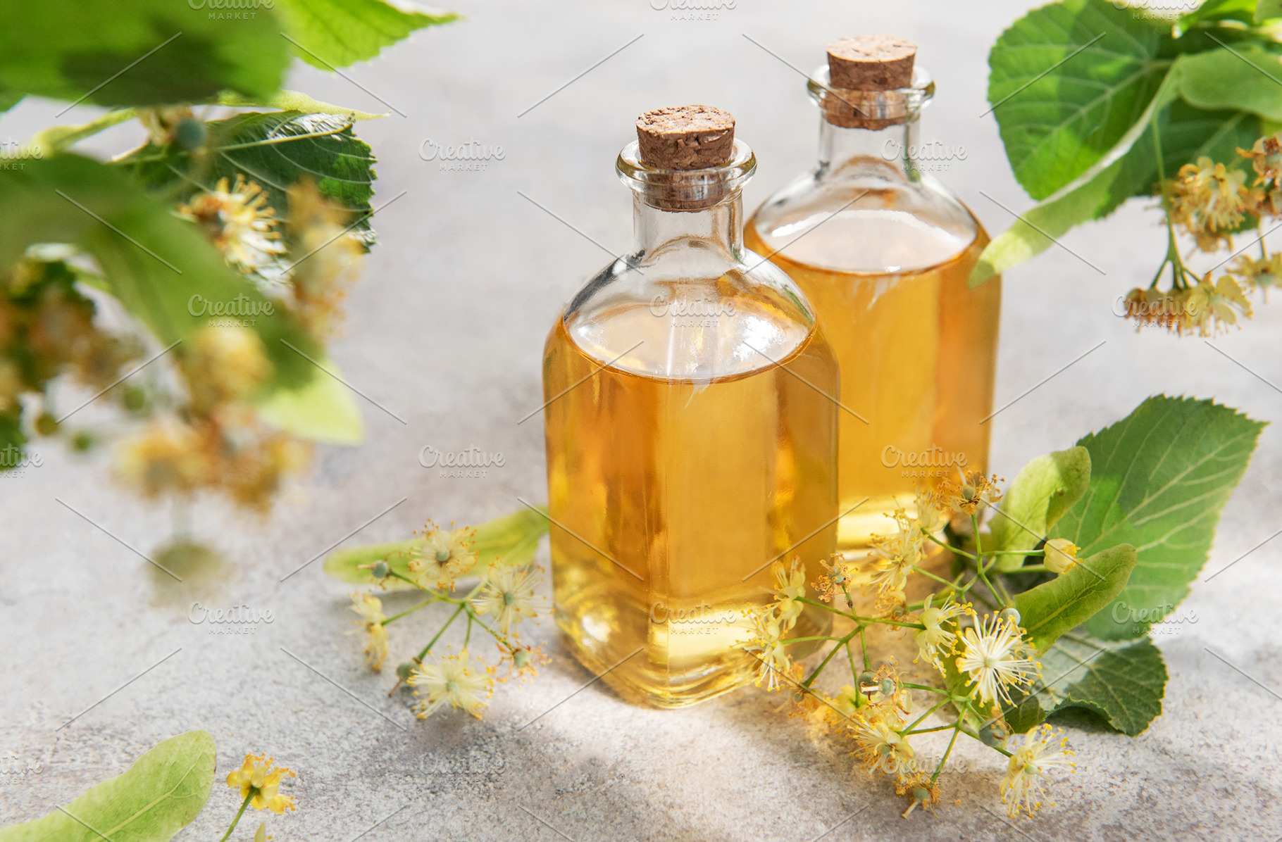Linden flower essential oil in glass bottles, a Health & Medical Photo by Olena Rudo