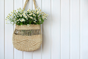Women's woven bag with a bouquet.