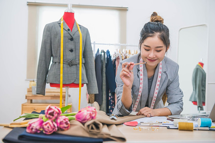 Attractive Asian female fashion designer  working in home office, a Beauty & Fashion Photo by Ministocker