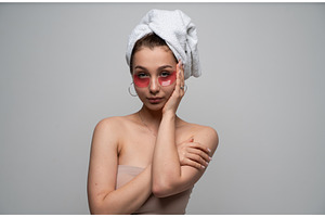 Young woman applying red hydrogel, a Health & Medical Photo by volodymyrshtun13795
