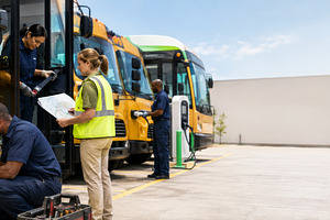 School bus maintenance scene with wo, a Photo by Dvoevnore photos