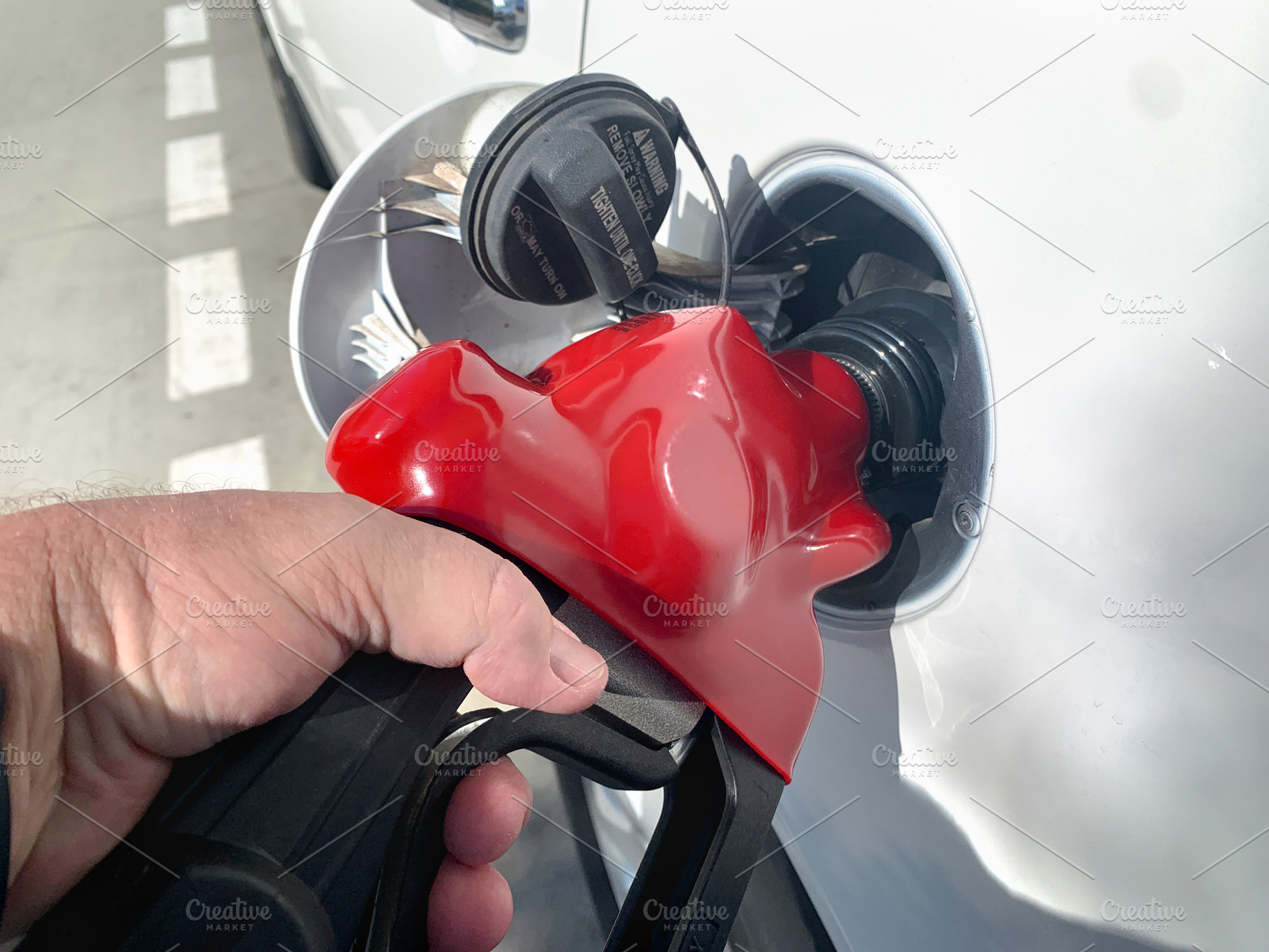 Male Hand Holding Gas Pump Nozzle, a Transportation Photo by Andy Dean Photography