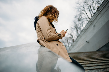 Young woman wearing beige trench coat, a Person Photo by progressman