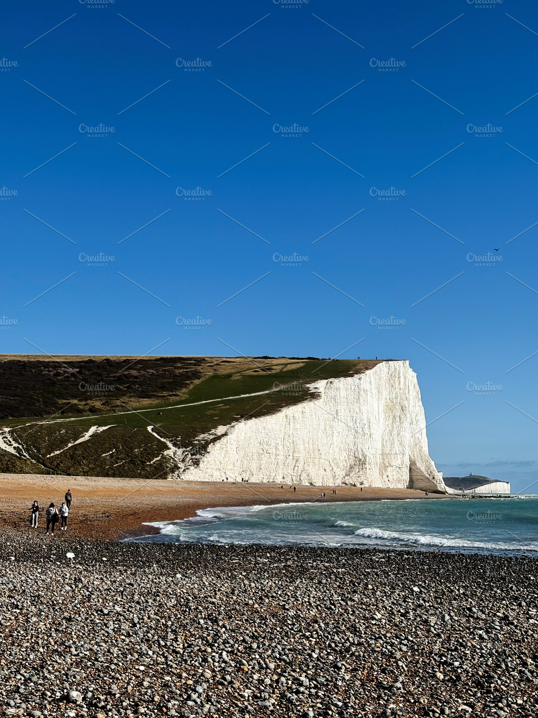 Hikers along the Seven Sisters Cliffs in East Sussex England with white chalk c, a Nature Photo by AS photostudio