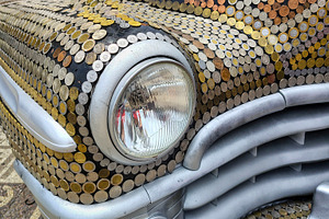 Antique car completely covered with a pattern of coins on its ex, a Transportation Photo by DanFLCreativo