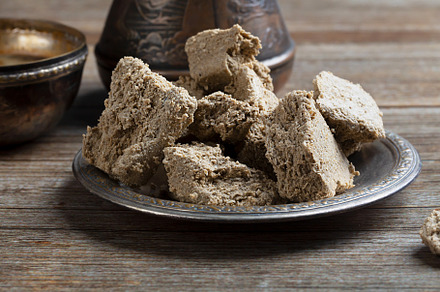 Vegetable-based halva sweet prepared from seeds on wooden background, a Food & Drink Photo by zakiroff