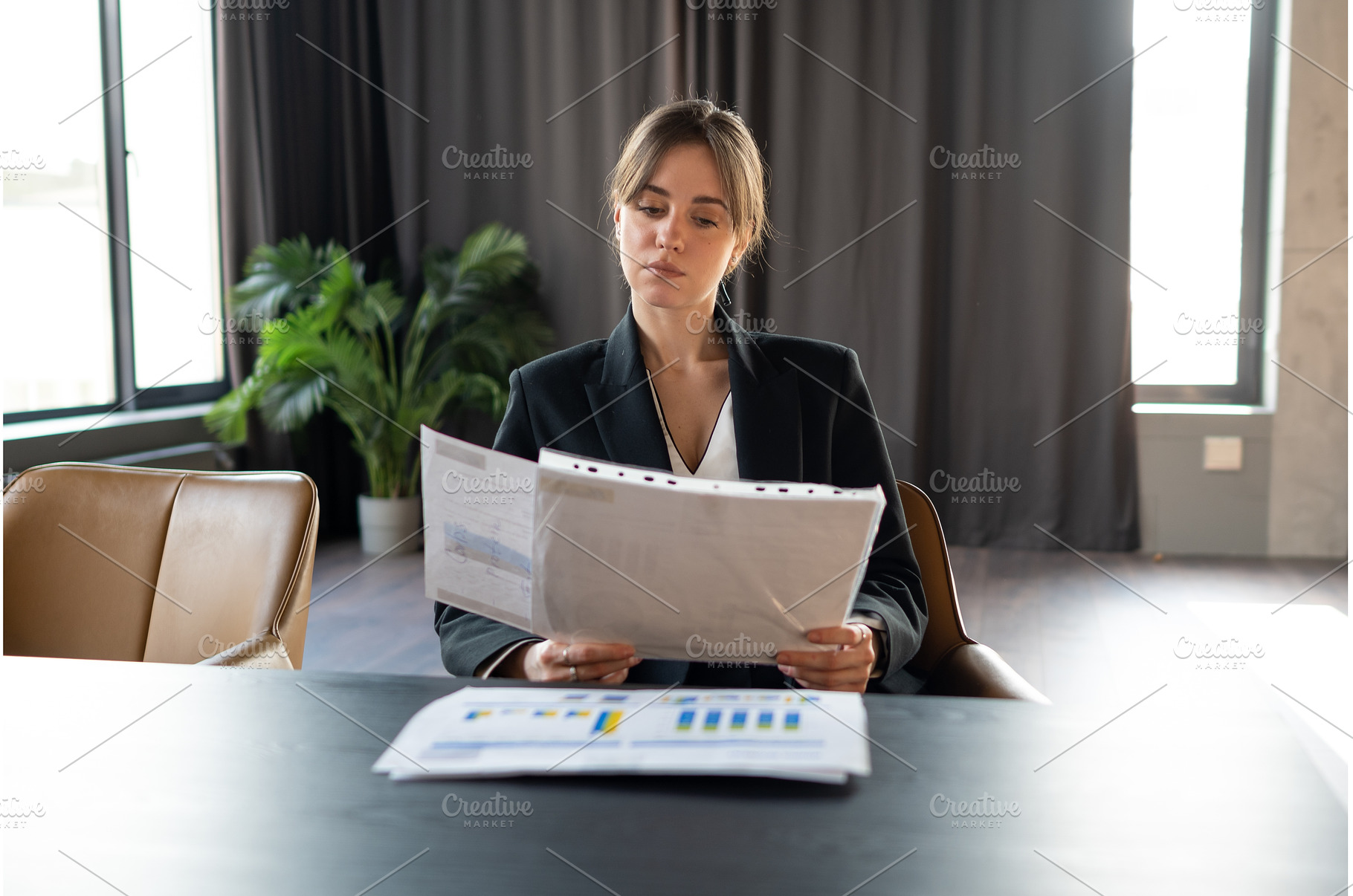Businesswoman in a formal black suit, a Business Photo by undrey