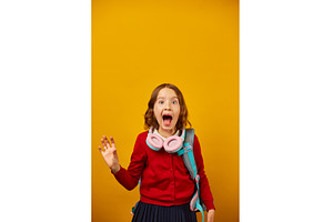 Excited girl wearing headphones, a School & Education Photo by IlliaBondarPhotography