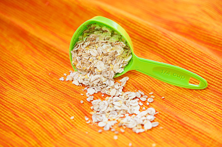 oatmeal in a volumetric spoon on a napkin Orange, a Food & Drink Photo by Artsaba Family