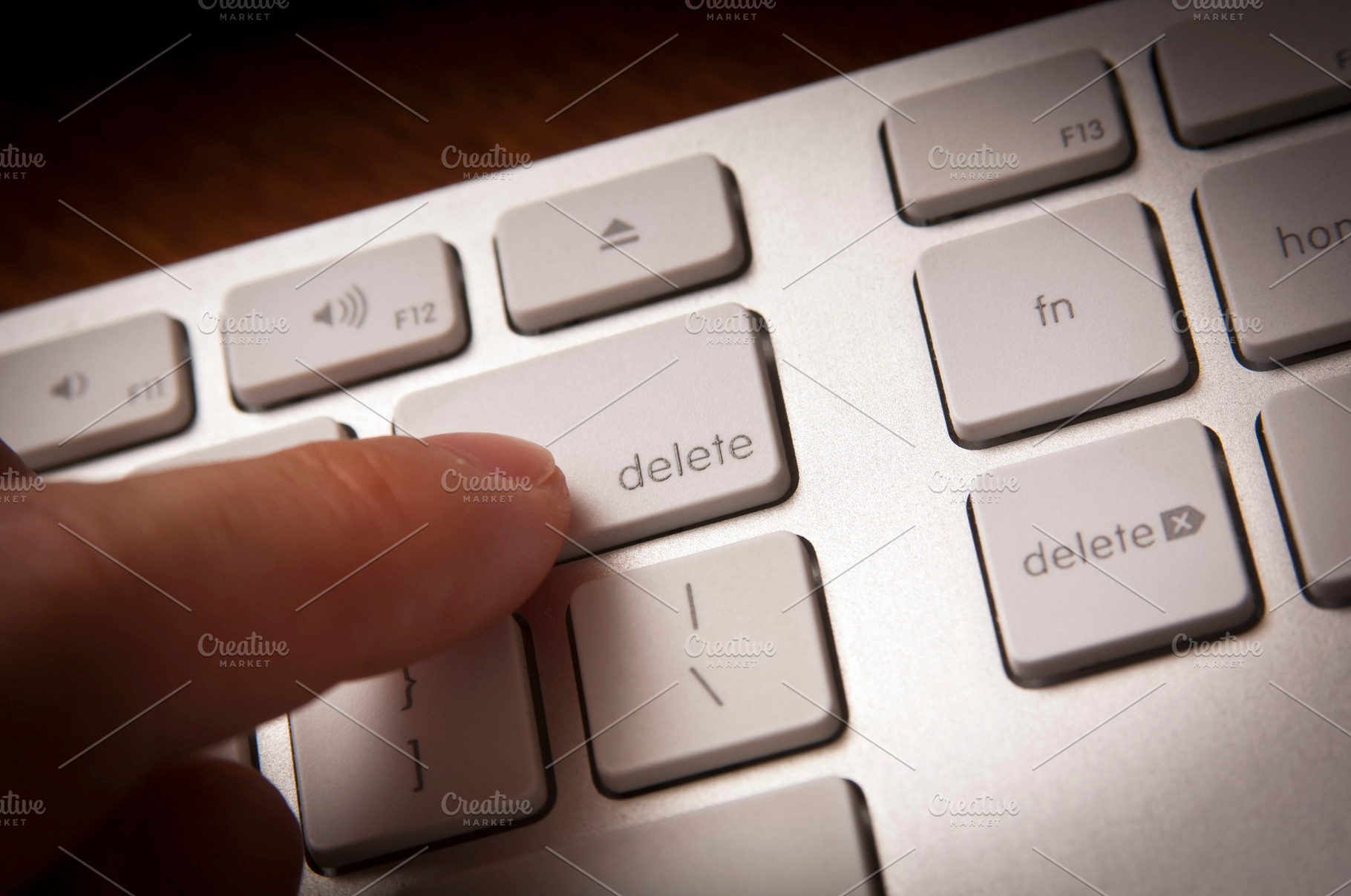 Finger Pressing Delete Key, a Technology Photo by THP Creative