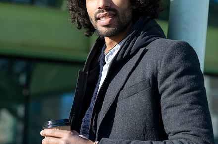 Handsome modern african american man with beard smiling positive standing at th, a Person Photo by RF Images