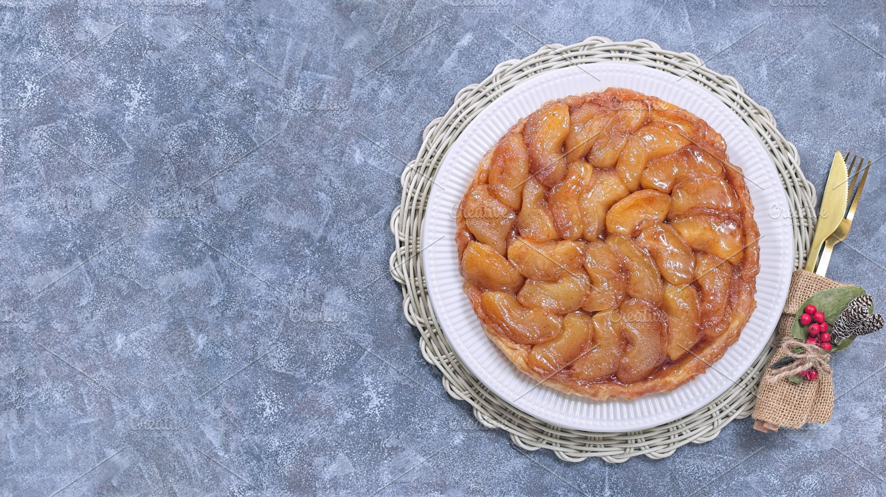 Delicious tarte tatin with caramelized apples, festive table setting, horizonta, a Food & Drink Photo by iuliia_n