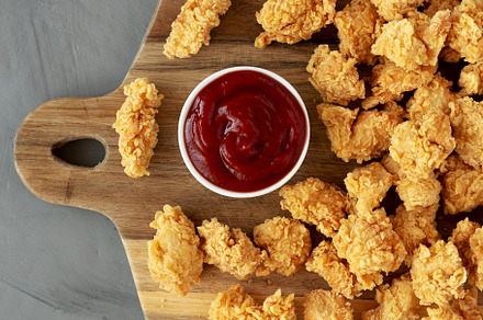 Homemade Crunchy Popcorn Chicken with Ketchup on a Board, top vi, a Food & Drink Photo by LiudmylaChuhunova