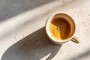 Overhead view of a single ceramic coffee cup on a textured surface with morning, a Food & Drink Photo by AlyaAnd