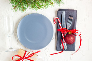 Christmas table place setting with stock photo containing table and dinner