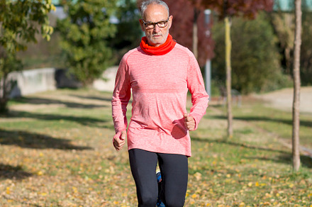 Senior man running outdoors in sportswear