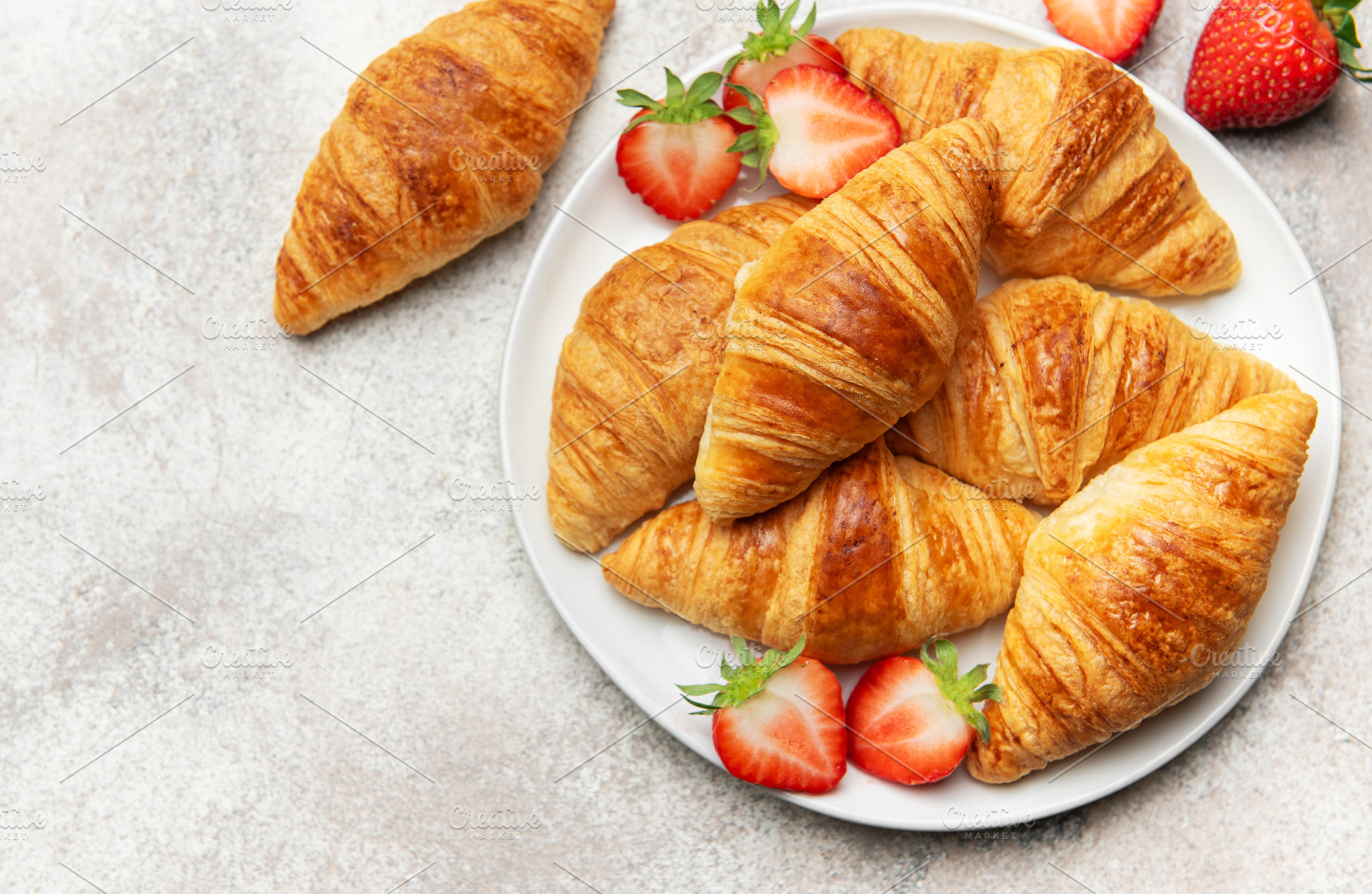 Freshly baked croissants with strawberries creating a delightful, a Food & Drink Photo by Olena Rudo