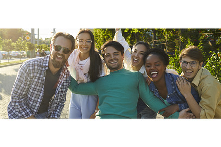 Happy young diverse friends standing, a Person Photo by StudioRomantic