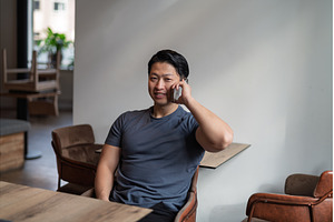Young asian man talking on phone, a Person Photo by HalfPoint