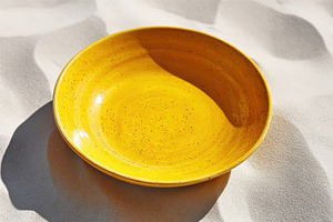 Golden honey syrup dripping on yellow plate in sunlight, a Background Photo by AlyaAnd