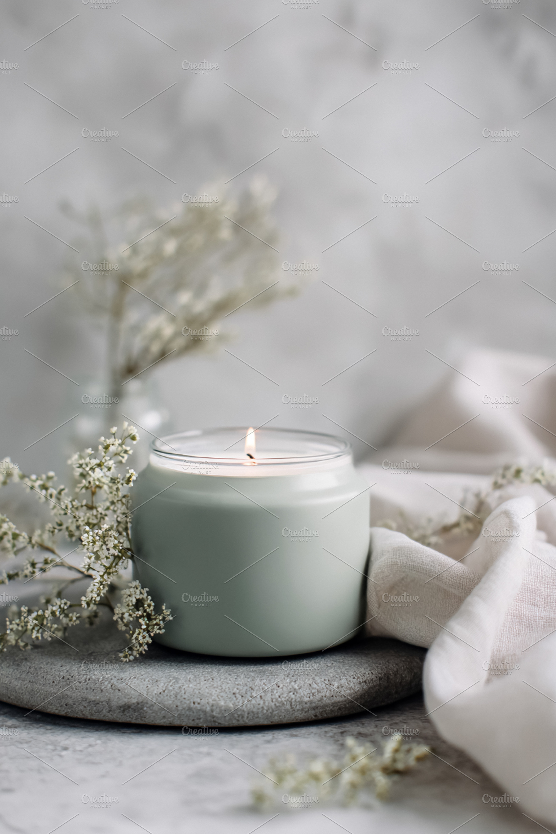 Lit candle creating a relaxing and tranquil atmosphere for aroma, a Photo by Studio ANNA