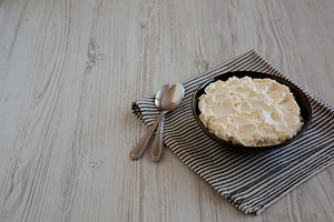 Organic White Mascarpone Cheese in a Bowl, side view. Copy space, a Food & Drink Photo by LiudmylaChuhunova