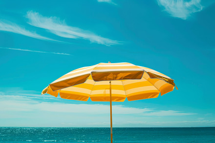 Yellow Striped Beach Umbrella Against Blue Sky, an Abstract Photo by Natalia Klenova's Shop