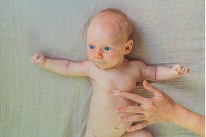 Mother applying anti-rash cream on, a Health & Medical Photo by Elizaveta Galitskaya