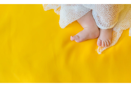 Baby feet on a yellow background, a Person Photo by yanadjana