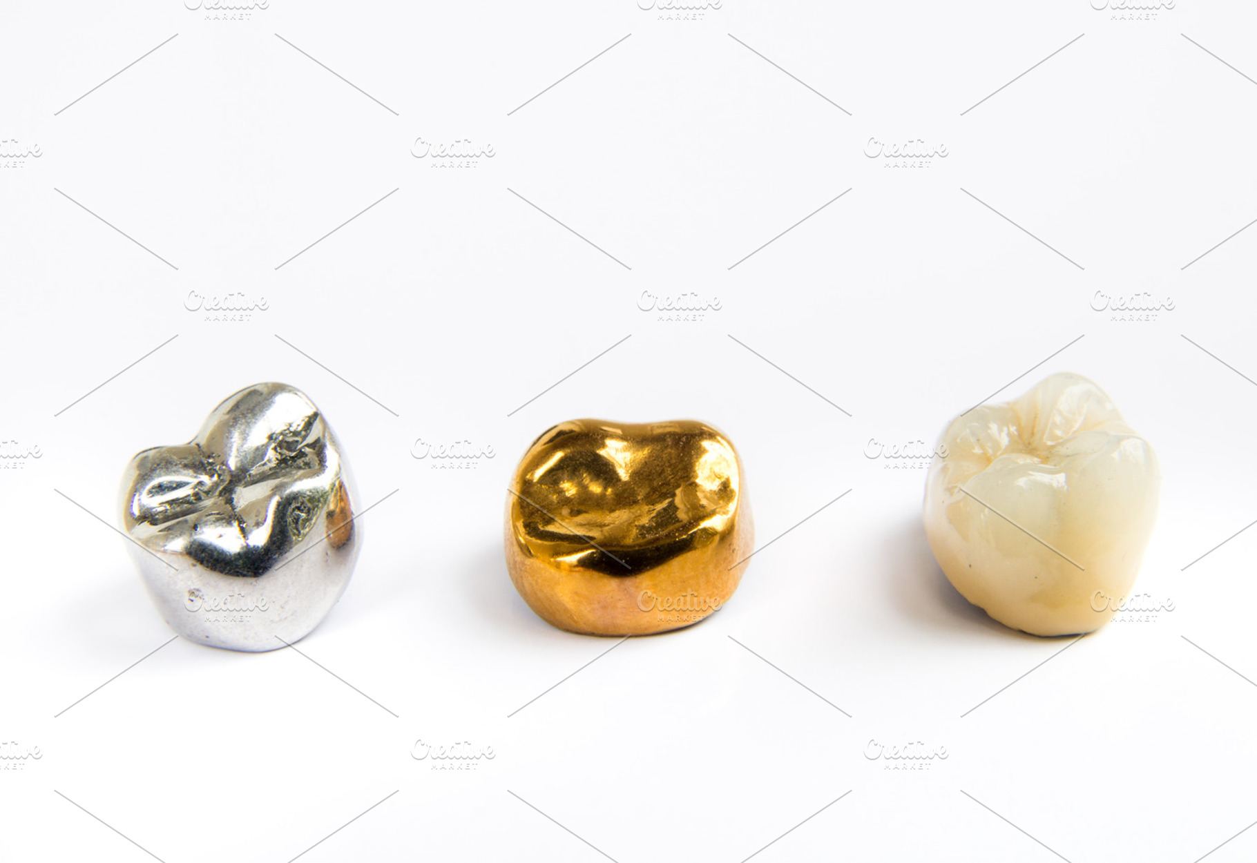 Dental ceramic gold and metal tooth crowns on white background isolated, a Health & Medical Photo by Life For Photo