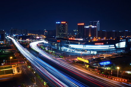 A lively urban landscape illuminated, a Photo by Tanuart