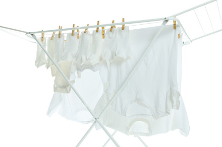 Drying rack with clothes, isolated on white background, a Beauty & Fashion Photo by AtlasStudio PRO