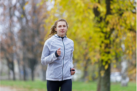 Young woman running in autumn park, a Sports & Recreation Photo by serkum