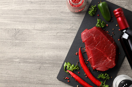 Concept of tasty food with raw beef steak, space for text, a Food & Drink Photo by AtlasStudio PRO