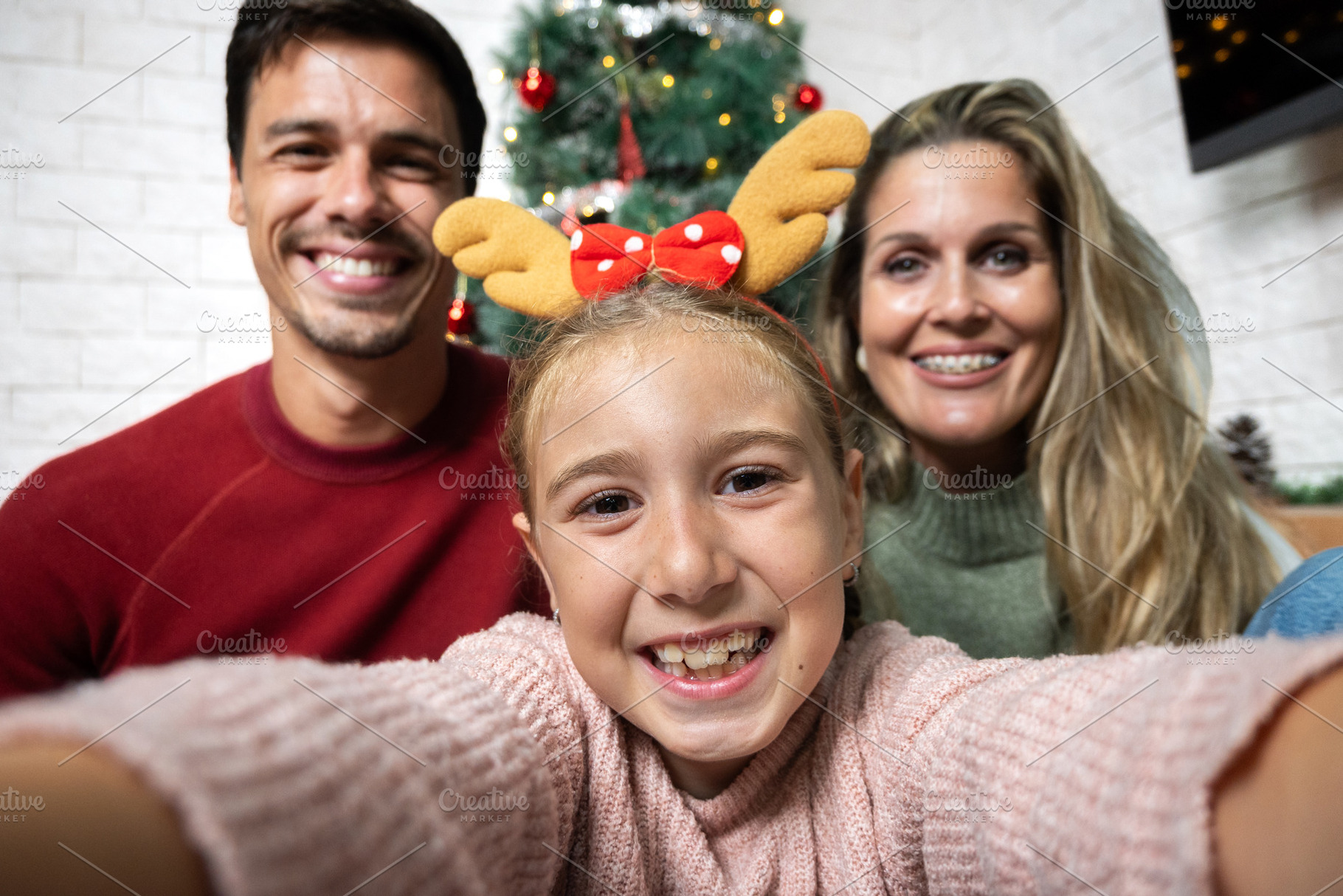 Happy family taking selfie together at Christmas, a Holiday Photo by etorres69
