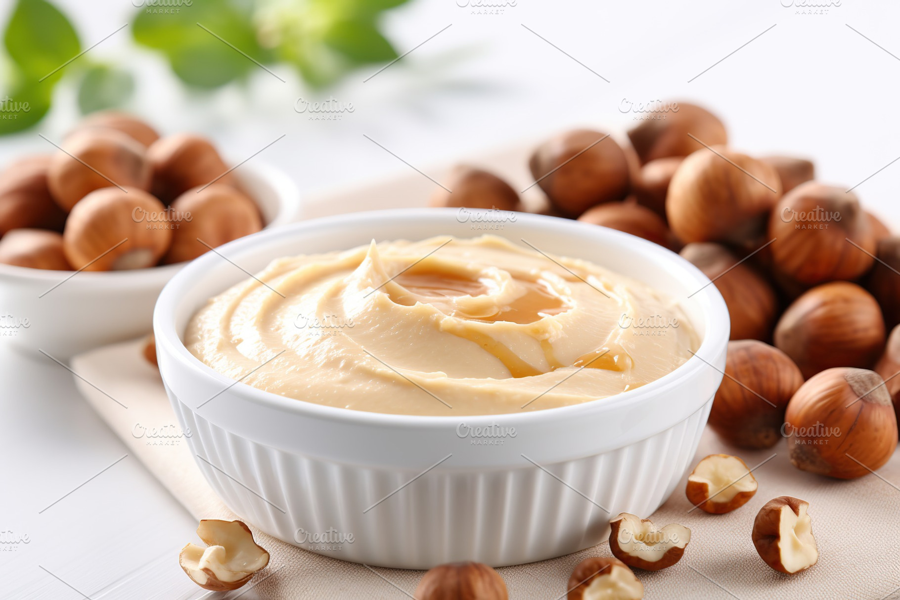 Bowl of hazelnut butter on wooden background, a Food & Drink Photo by AlyaAnd
