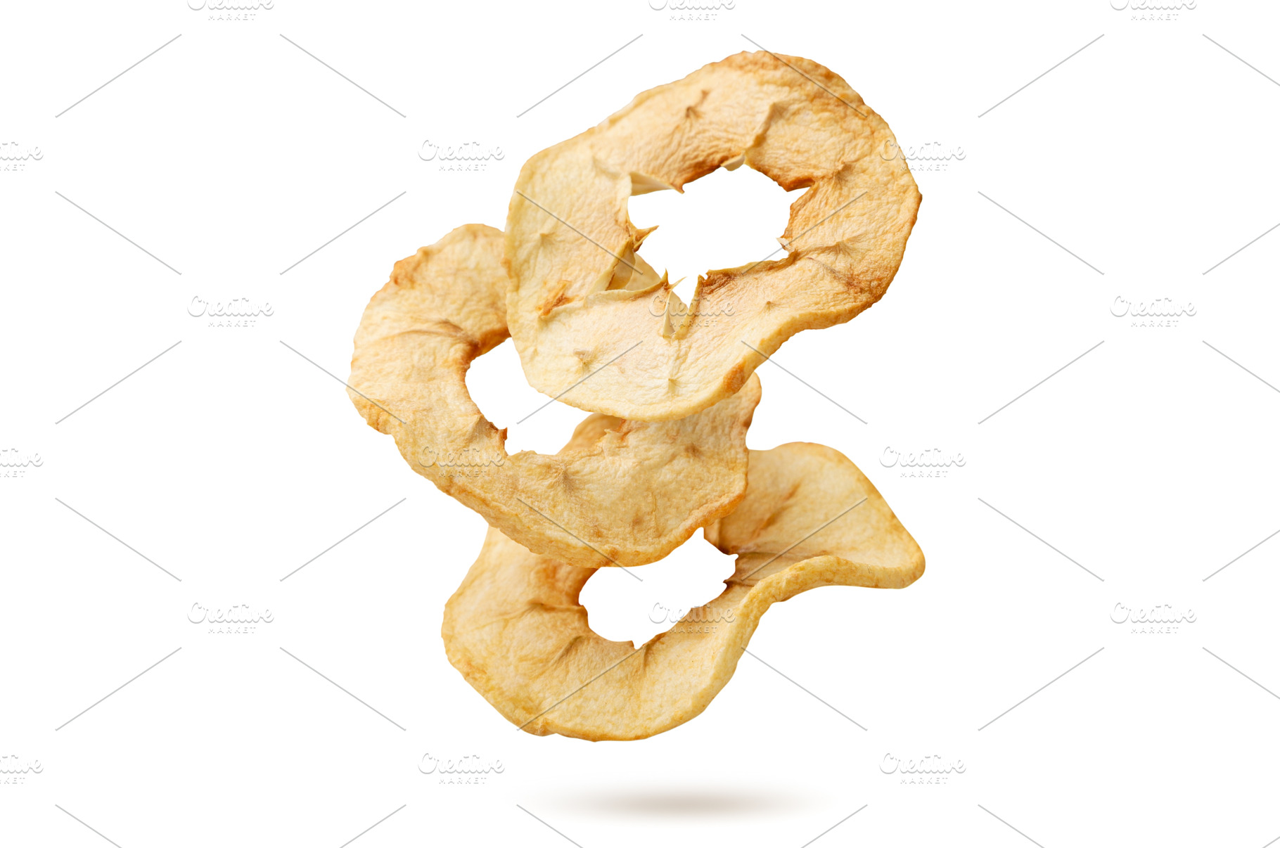 Pieces of dried apples flying on a, a Food & Drink Photo by innakreativ