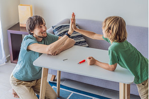 Father and his son assembling a, a Person Photo by Elizaveta Galitskaya