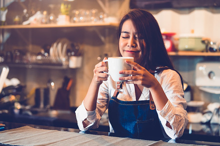 Beauty Asian female barista holding cup of coffee and tasting br, a Person Photo by Ministocker