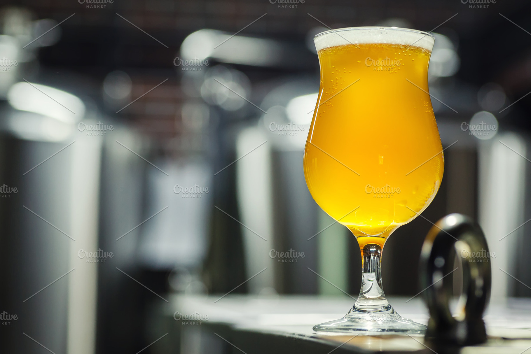 Tulip glass of light beer in a brewe stock photo containing alcohol and ale, a Food & Drink Photo by Hidden Hallow