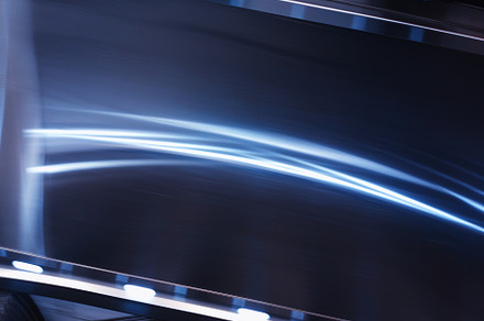 Dramatic curved light reflections on metal surface