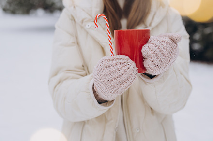 Cute happy woman holding hot coffee, a Holiday Photo by Cherkas Photography