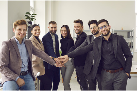 Smiling coworkers putting their, a Person Photo by StudioRomantic