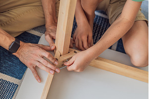 Father and his son assembling a, a Person Photo by Elizaveta Galitskaya